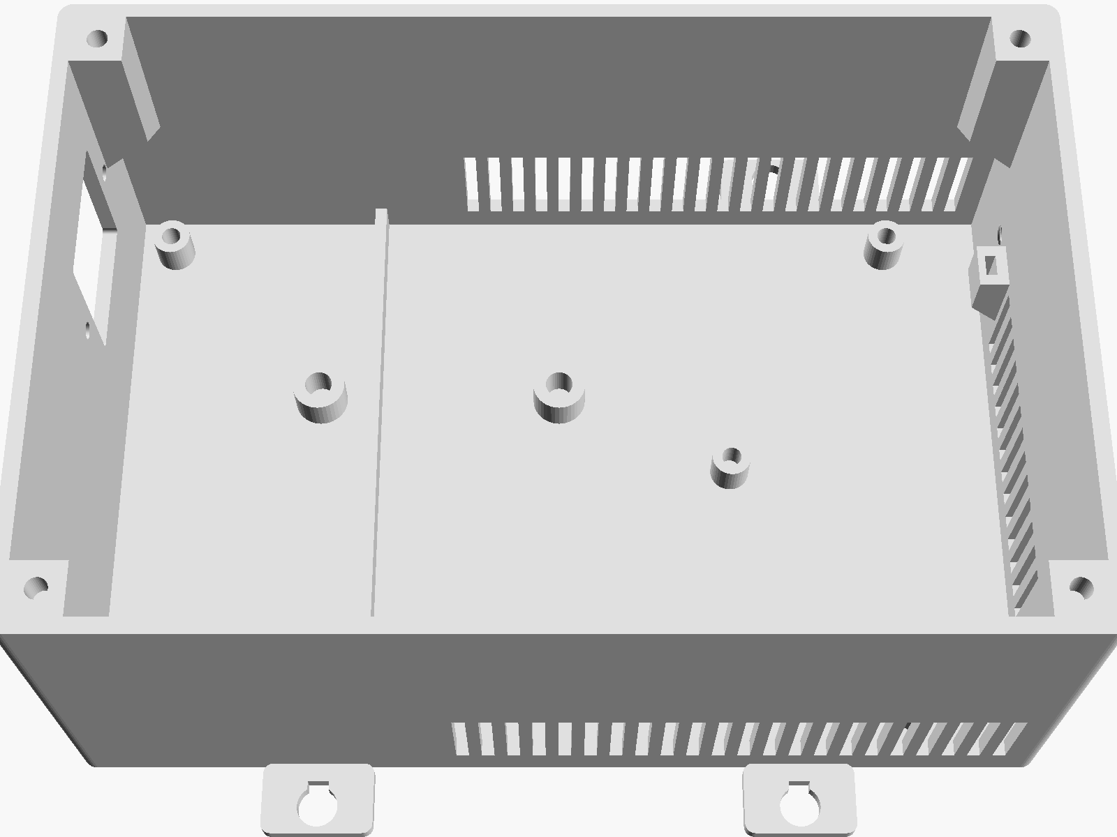 Render looking down into the empty tub: the IEC inlet cut-out in the left end wall, four large transformer bosses and the board standoffs on the floor, the low floor rib, lid-screw corbels in the corners and vent slots in the side and right end walls.